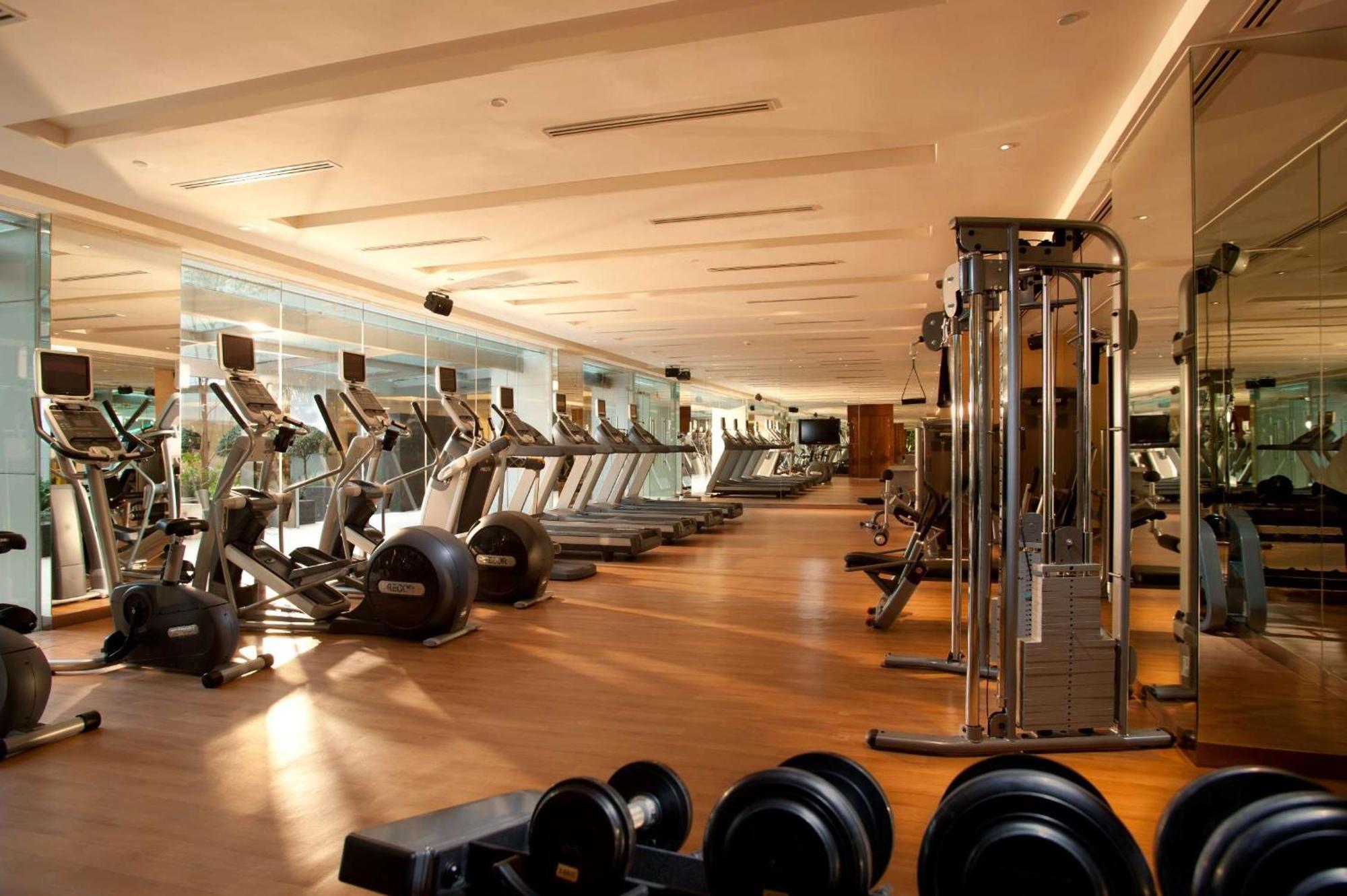 Doubletree By Hilton Kuala Lumpur Hotel Екстериор снимка The photo shows a modern gym interior. It features various fitness equipment including treadmills, exercise bikes, and weight machines. The gym has a spacious layout with large windows that allow natural light to enter, creating a bright and inviting